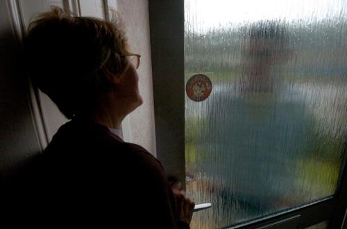 Woman at open door with person on door step